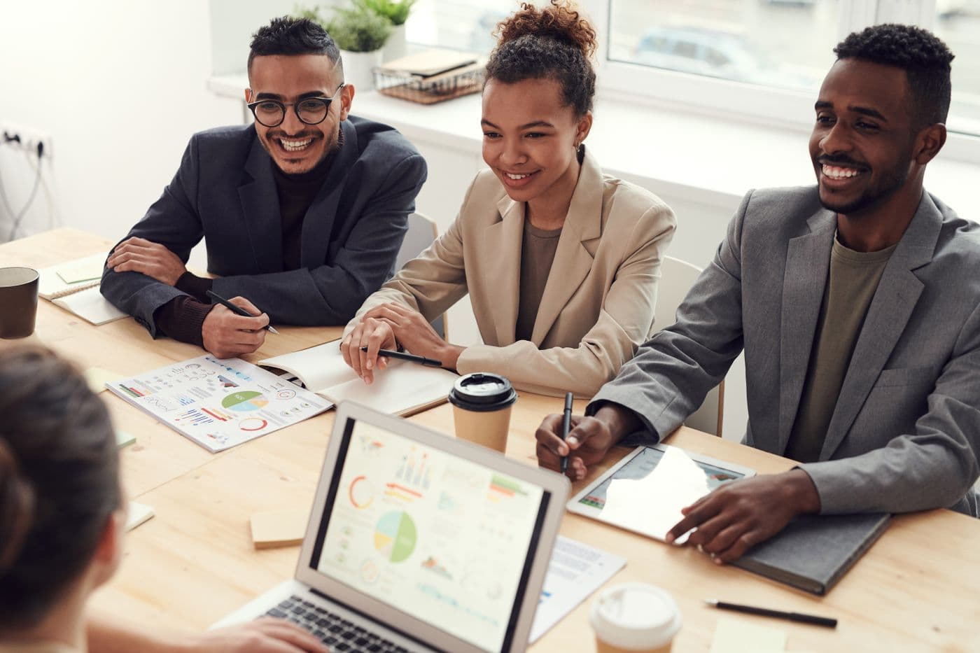 Three business owners smiling during a meeting